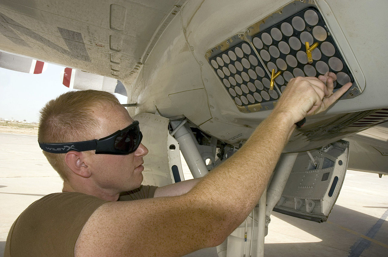 A sailor services an AN/ALE-47 countermeasures dispenser on a P-3 Orion. (USN)