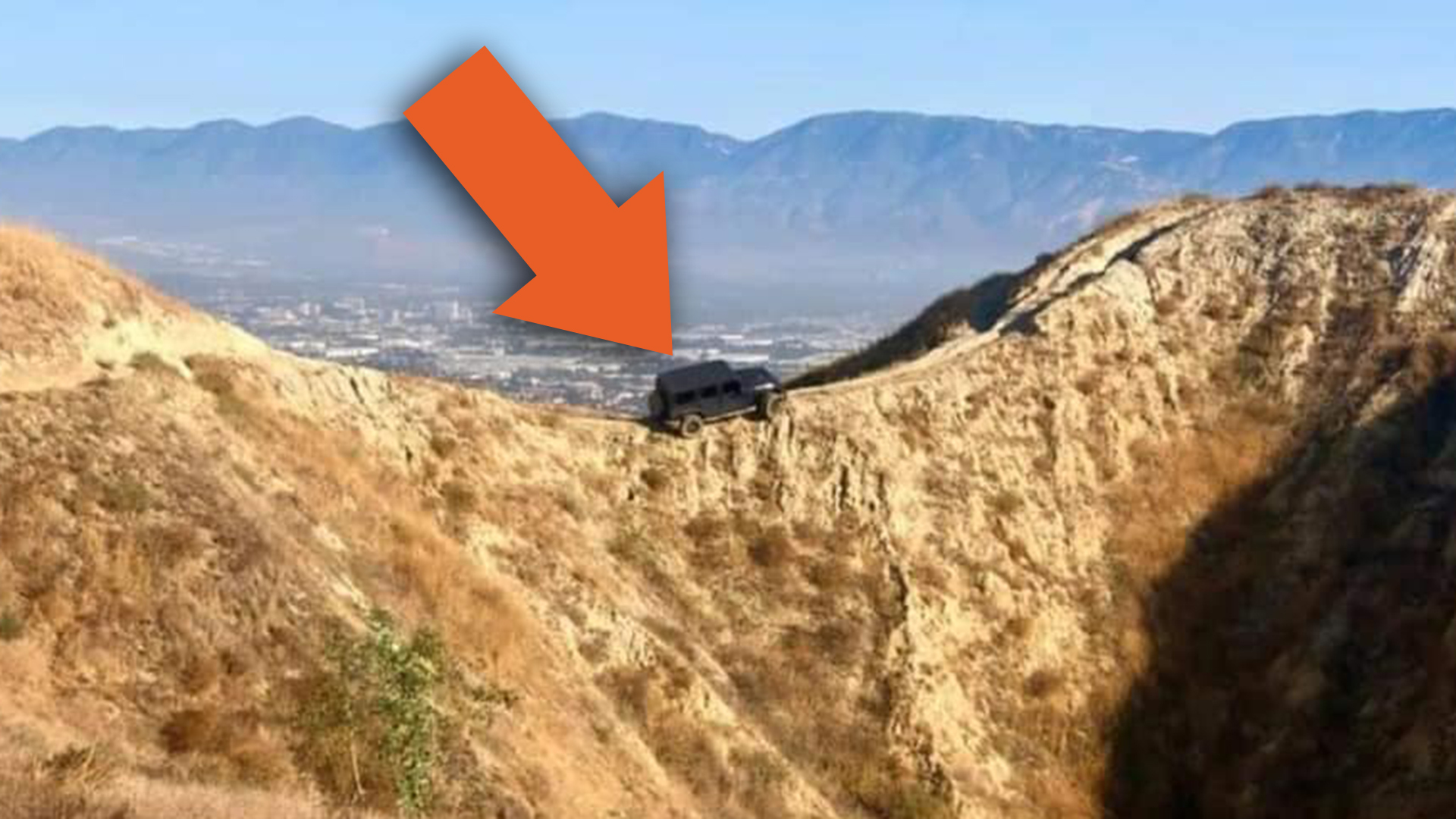 There's a Jeep Wrangler Dangling Off a Cliff in California After Some Fool Drove Up a Bike Trail