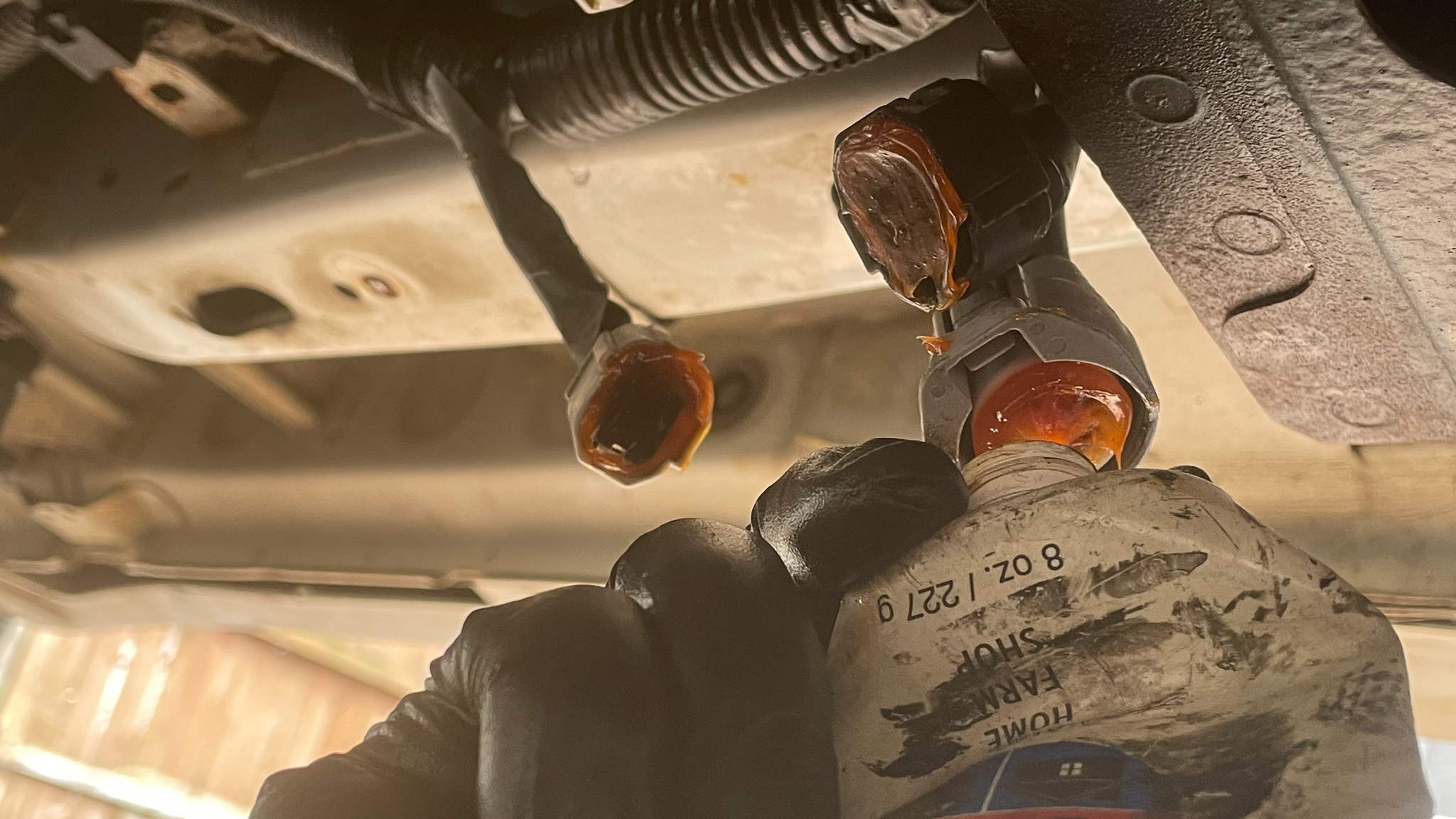 Dielectric grease being applied in an EV battery sensor plug