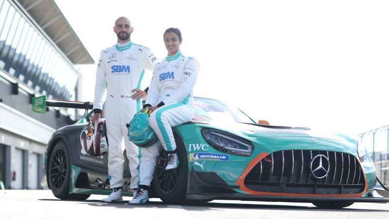 Reema Juffali and Adam Christodoulou standing next to the Theeba racing AMG GT3 car