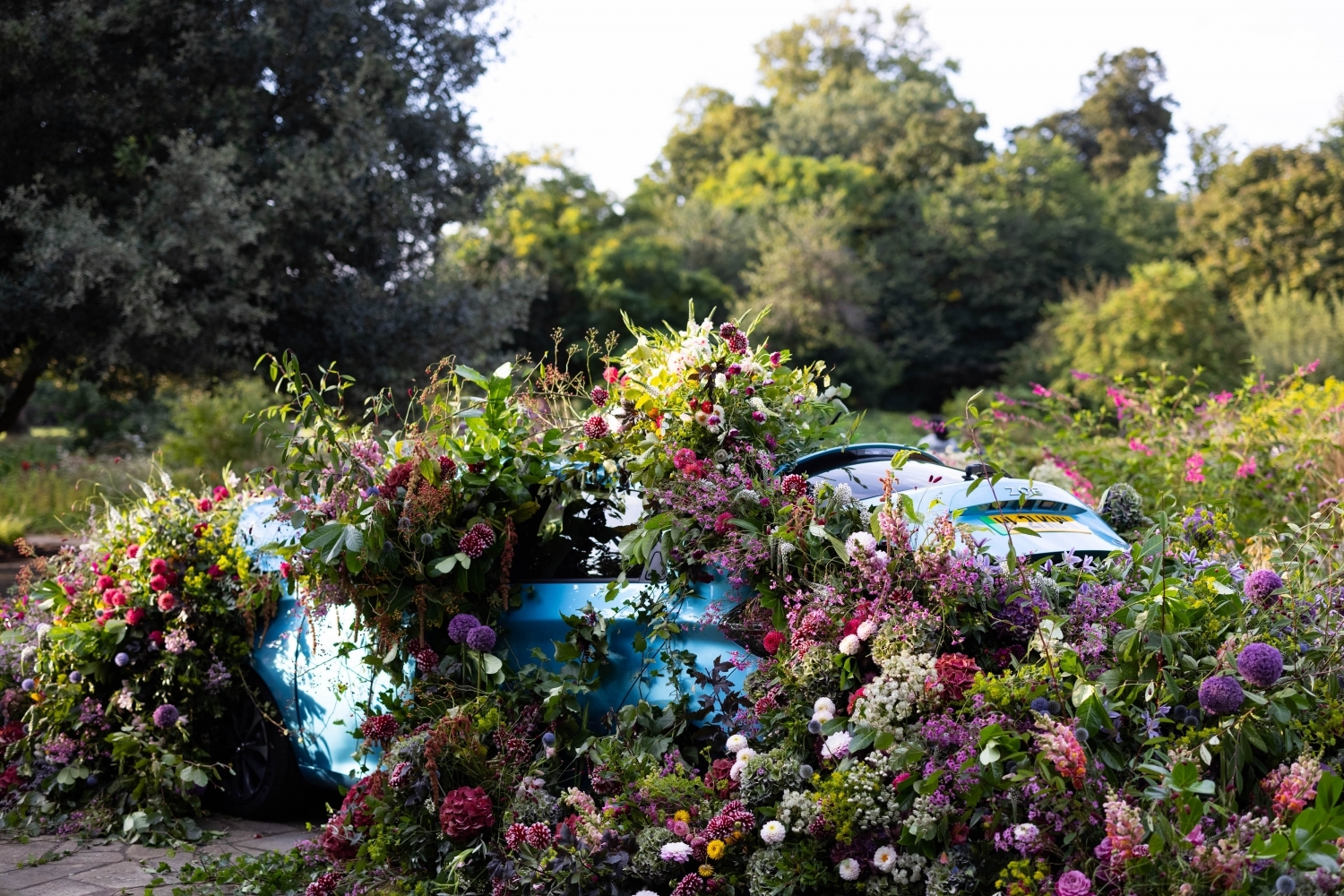 A Renault Zoe filled with wildflowers, spilling out of every door