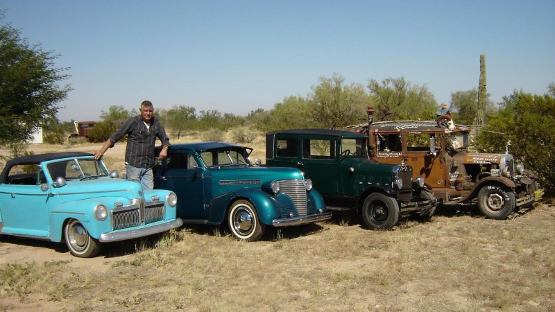 Ernie Adams stands by his miniature car creations, none of which come above elbow height