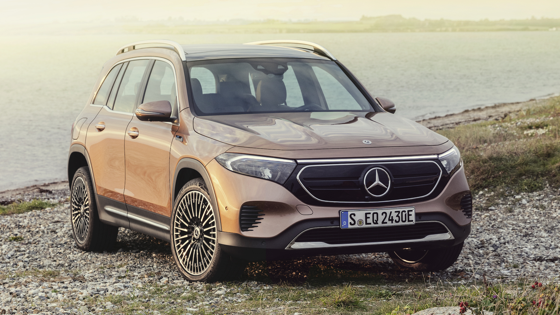 A Mercedes-Benz EQB crossover faces the camera by a coastal cliff