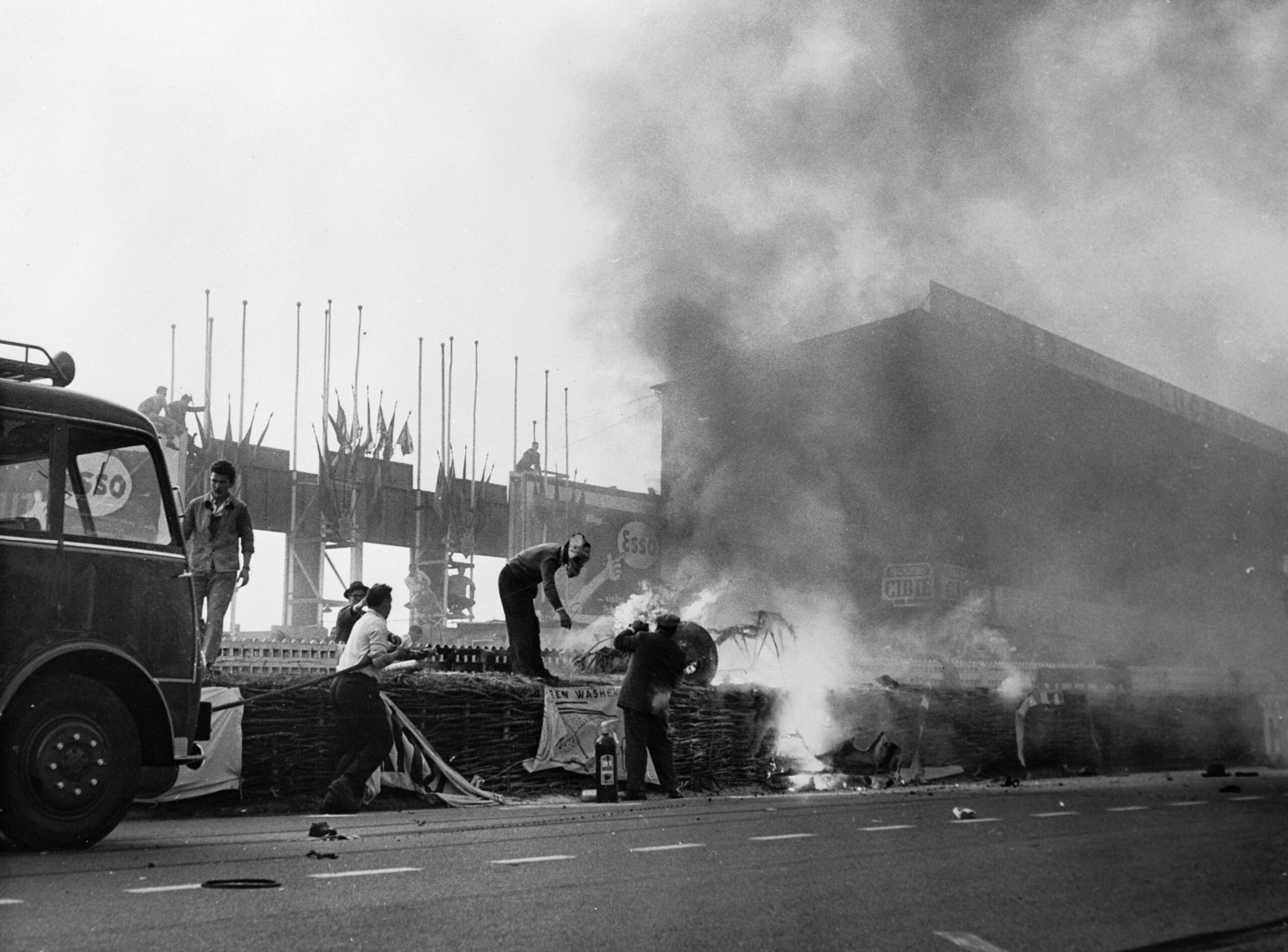 Firemen Putting Out a Fire at Le Mans in 1955 following Pierre Levagh's disastrous crash