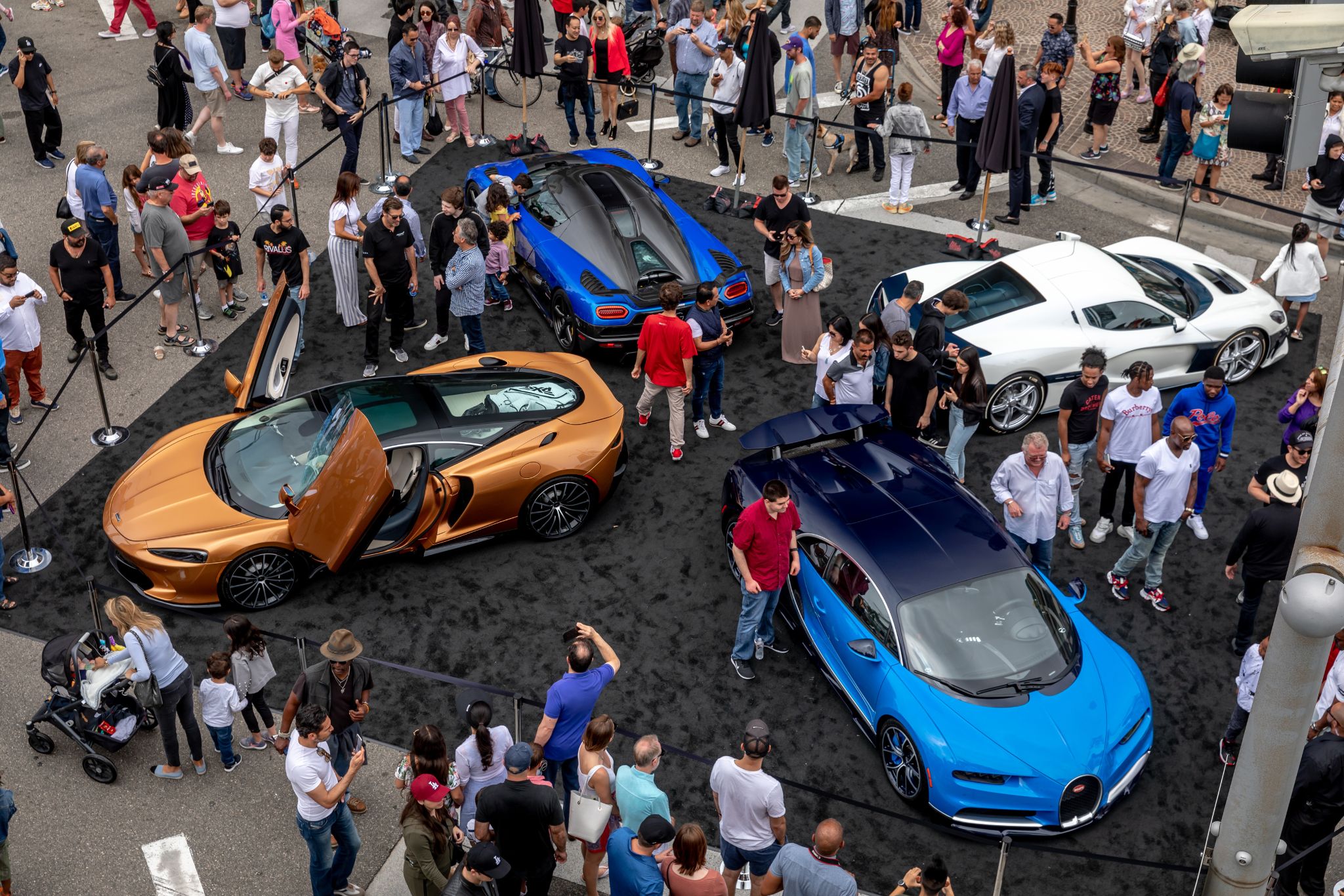 four supercars in a crowd