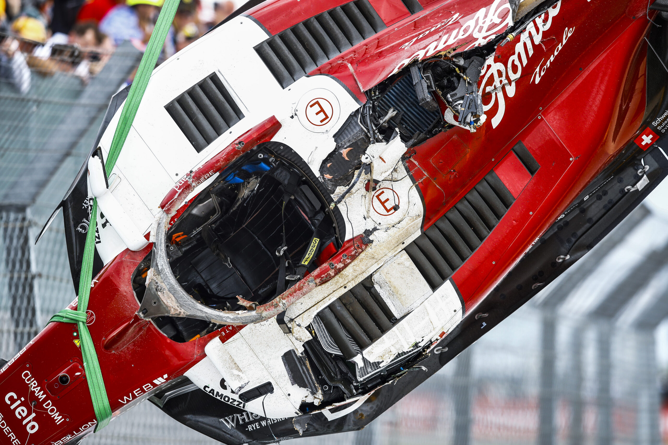 Guanyu Zhou's car after the crash, showing the whole top crash structure is missing with just bare carbon fibre beneath