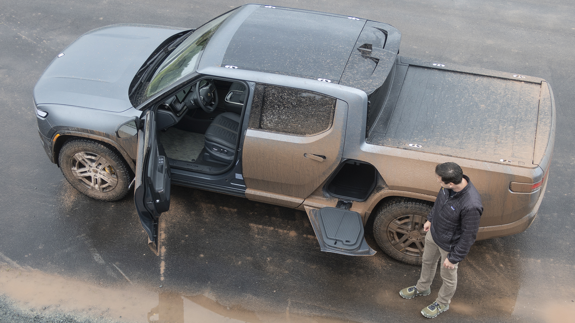 Mud-covered Rivian R1T truck.