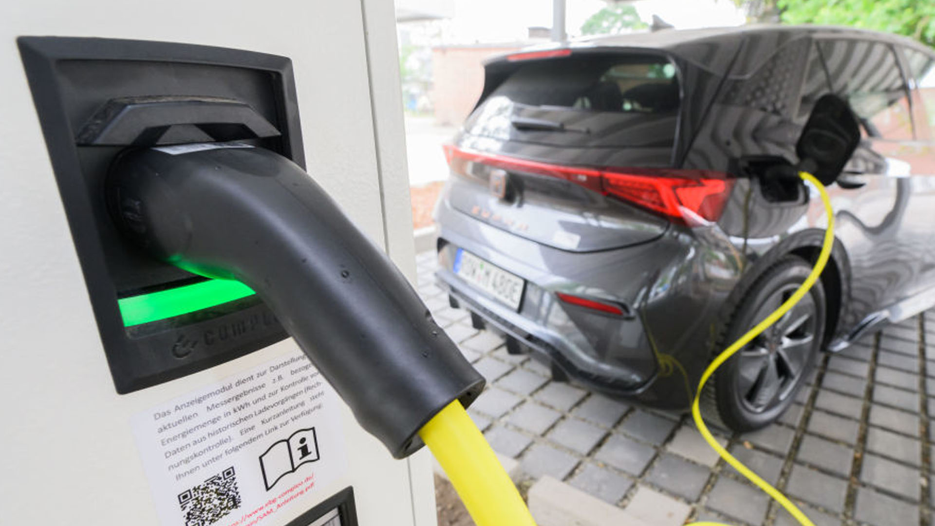 A charge cable plugged into a VW ID.4 at a public charging station