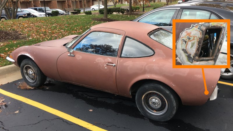 A lovely rusty 1970 Opel GT in a parking lot.