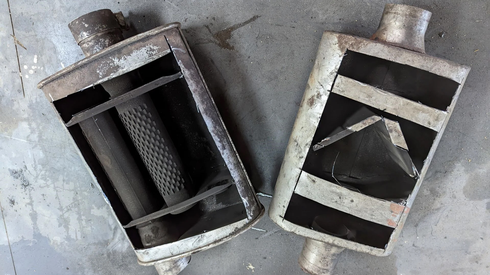 A turbo muffler next to a chambered muffler.