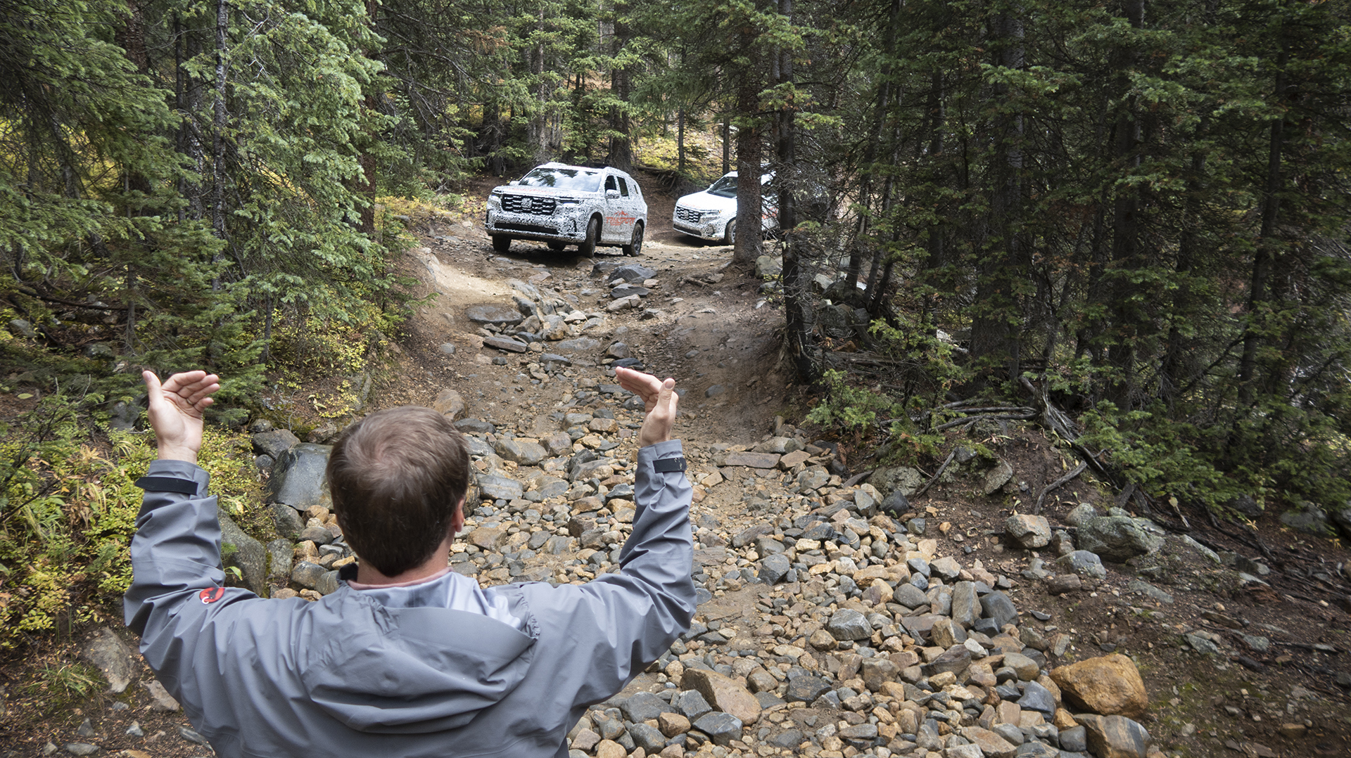 2023 Honda Pilot TrailSport being directed on a trail by a spotter.