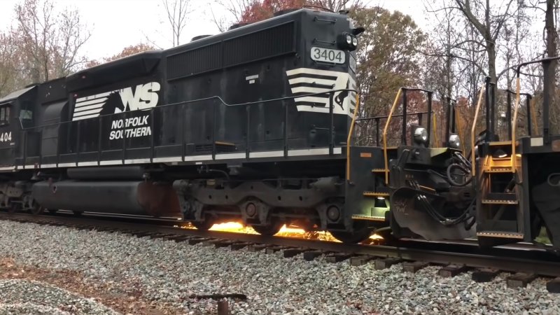 Norfolk Southern locomotive sprays sparks from its wheels