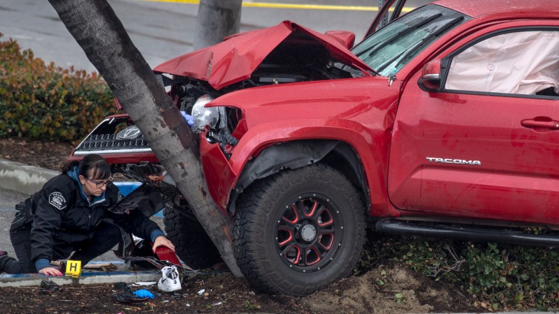 FULLERTON, CA - FEBRUARY 10: Heather Barclay, an accident investigator with the Fullerton Police Department, gathers evidence that was lodged underneath a pickup truck. The driver, identified as Christopher Solis, 22, veered onto a sidewalk and hit 9 pedestrians, police said. Some of the victims were trapped beneath the truck, according to authorities. (Photo by Mindy Schauer/MediaNews Group/Orange County Register via Getty Images)