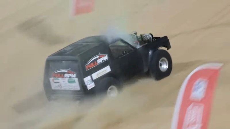An SUV races up Moreeb Dune