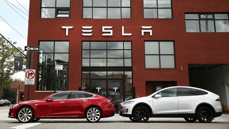 Tesla Model X and Model S outside of a Tesla store.