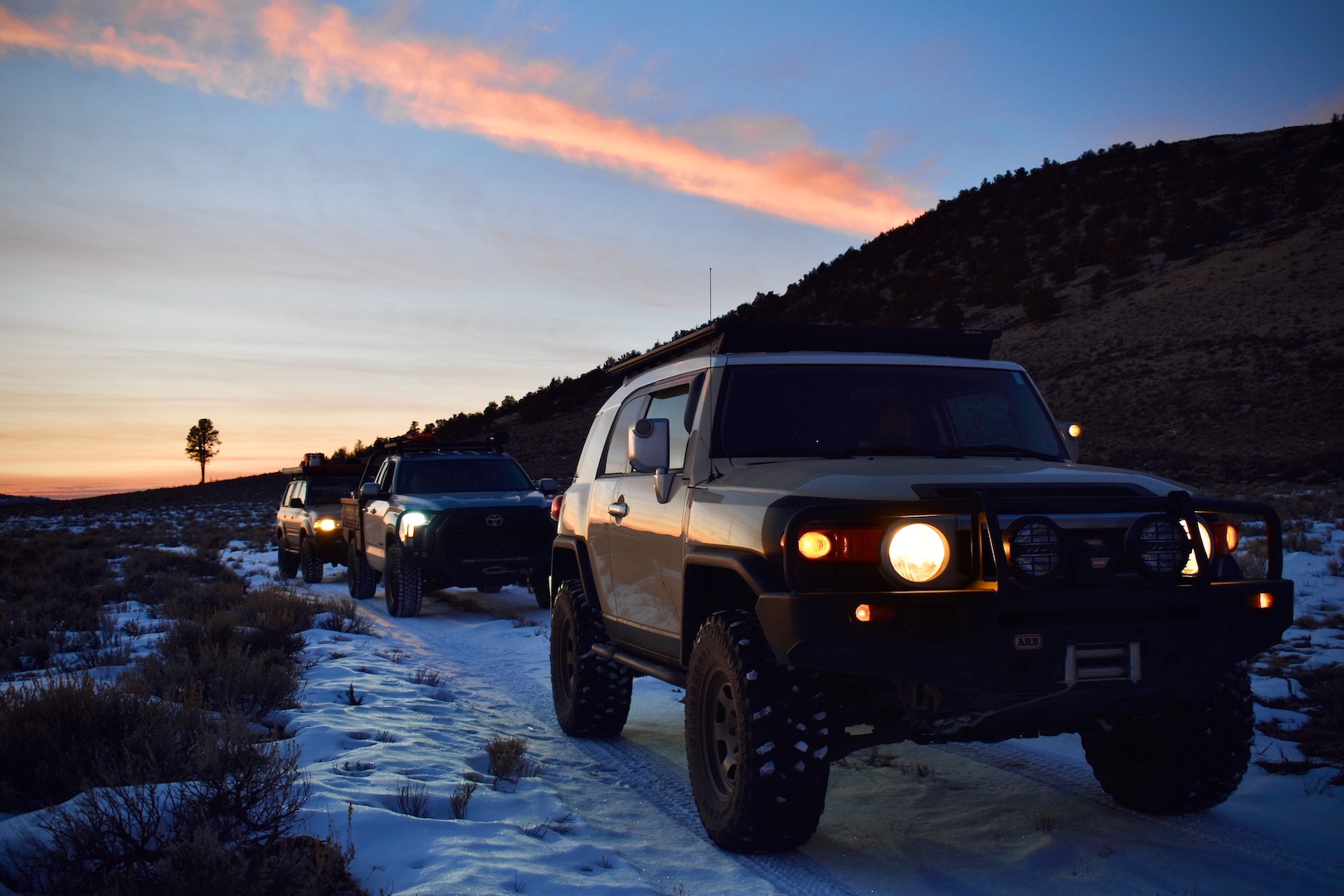 Toyota FJ Cruiser, Tundra, and Land Cruiser (80-series) at dusk