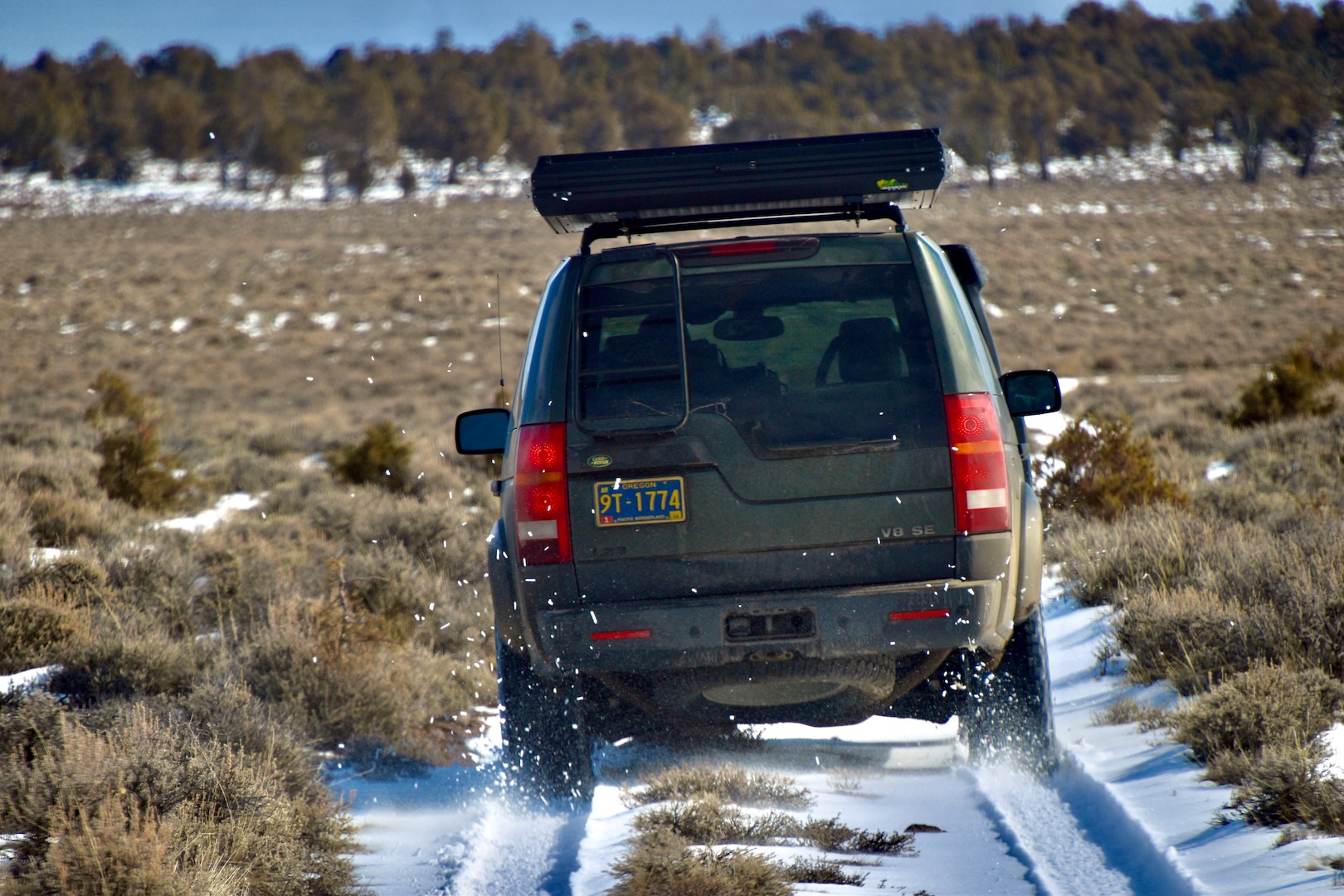 A Land Rover LR3 kicks up snow