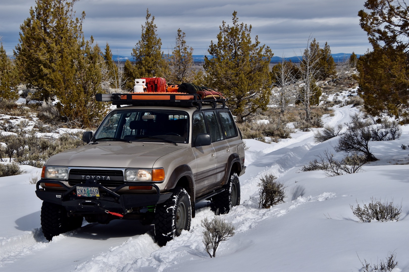 A Toyota Land Cruiser (80-series) stops for rest in a snowy forest