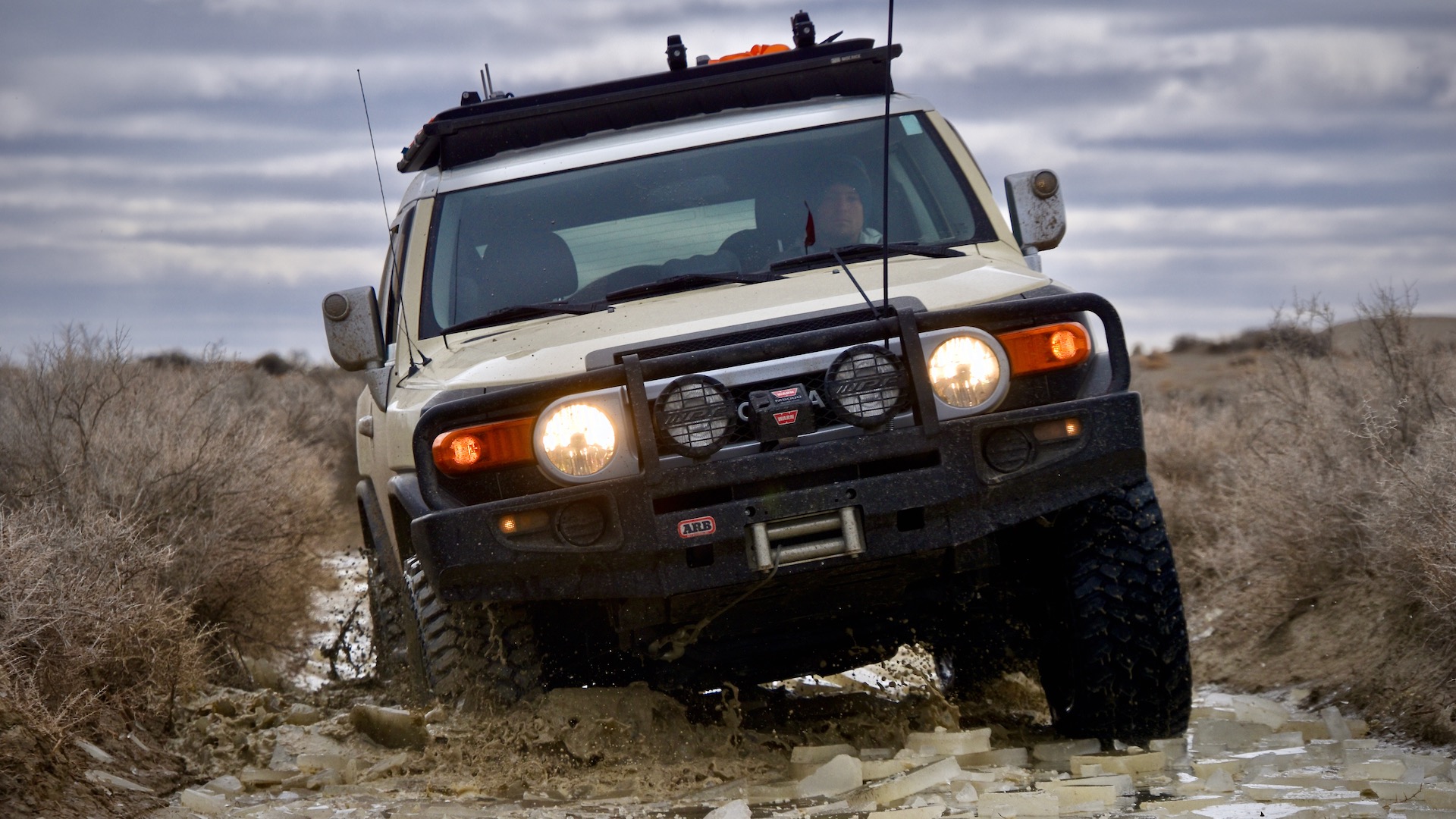 A Toyota FJ Cruiser cracks through a frozen river in the Oregon desert