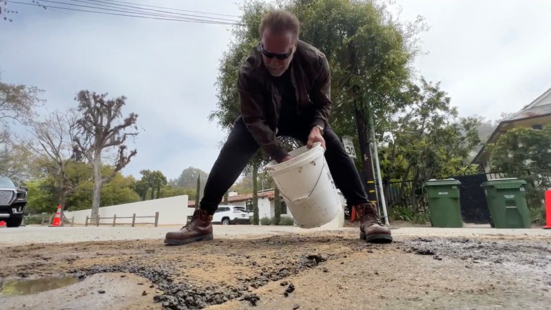 Arnold Schwarzenegger repairing a street in Los Angeles, California