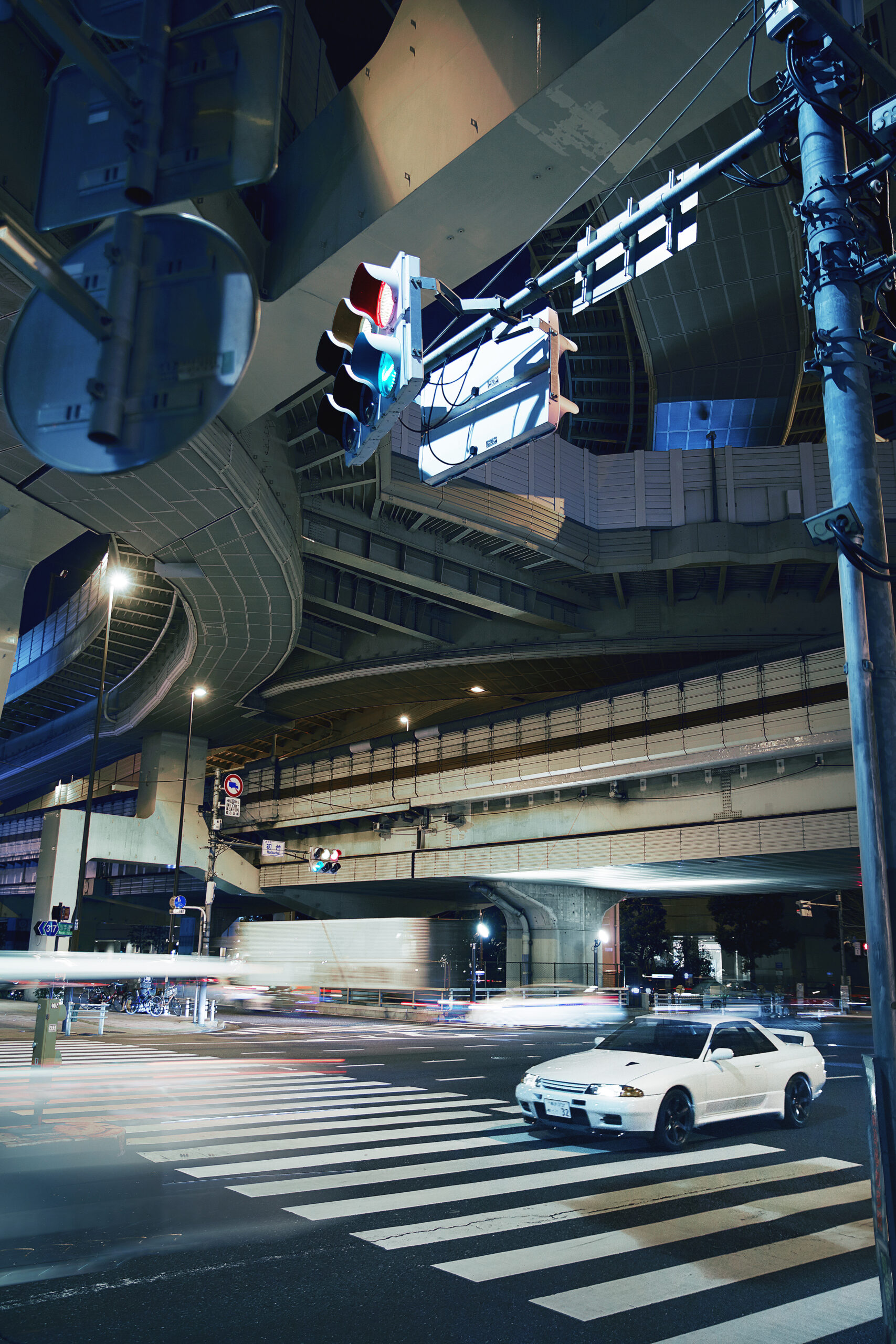 Nissan GT-R by Built By Legends along a Japanese highway at night.