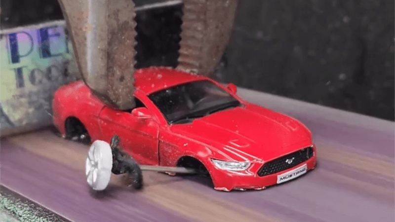 Watch a Belt Sander Slowly Erase All These Toy Cars