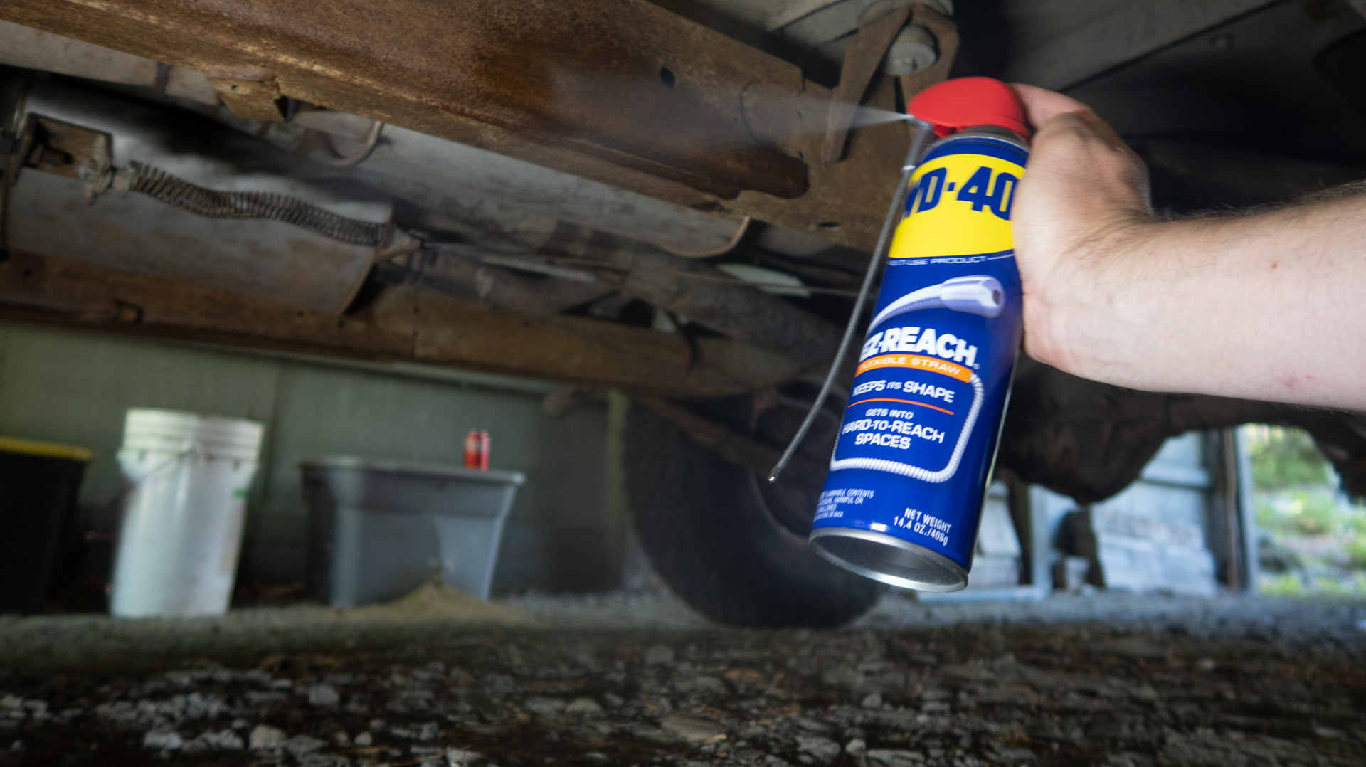 WD-40 EZ-REACH original formula being sprayed at a truck frame.