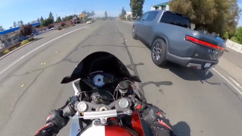 Helmet camera footage from a Kawasaki motorcycle rider as they try to distance themselves from an aggressively driving grey Rivian R1T