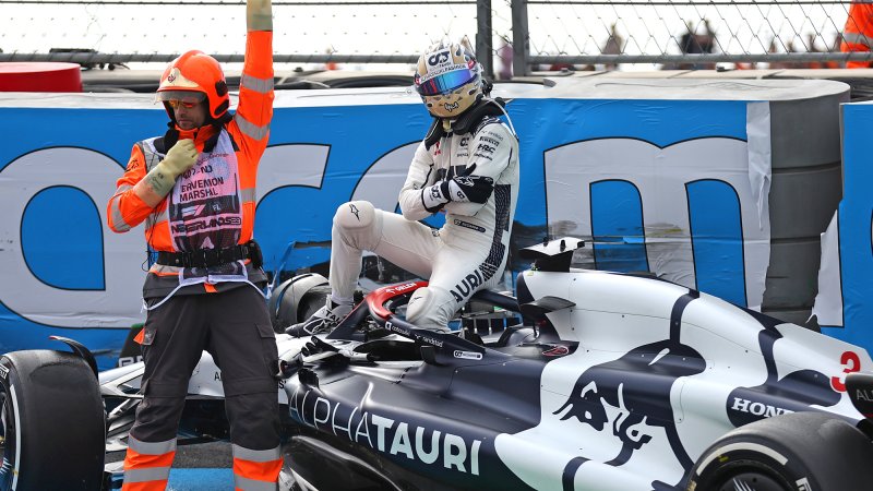 Daniel Ricciardo sits on top of his crashed AlphaTauri F1 car during Friday practice for the 2023 Dutch Grand Prix.