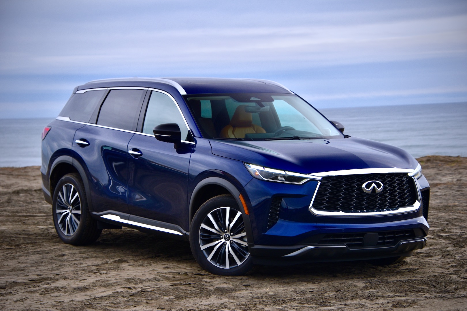 2023 Infiniti QX60 Sensory AWD against the Pacific Ocean