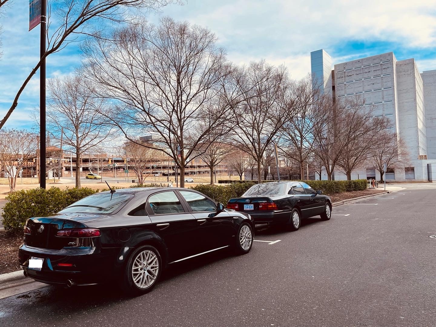 2009 Alfa Romeo 159 diesel in the United States, in black, from the rear three-quarter angle