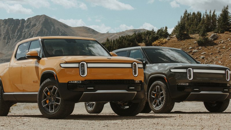 Rivian R1T pickup trucks against a mountainous background