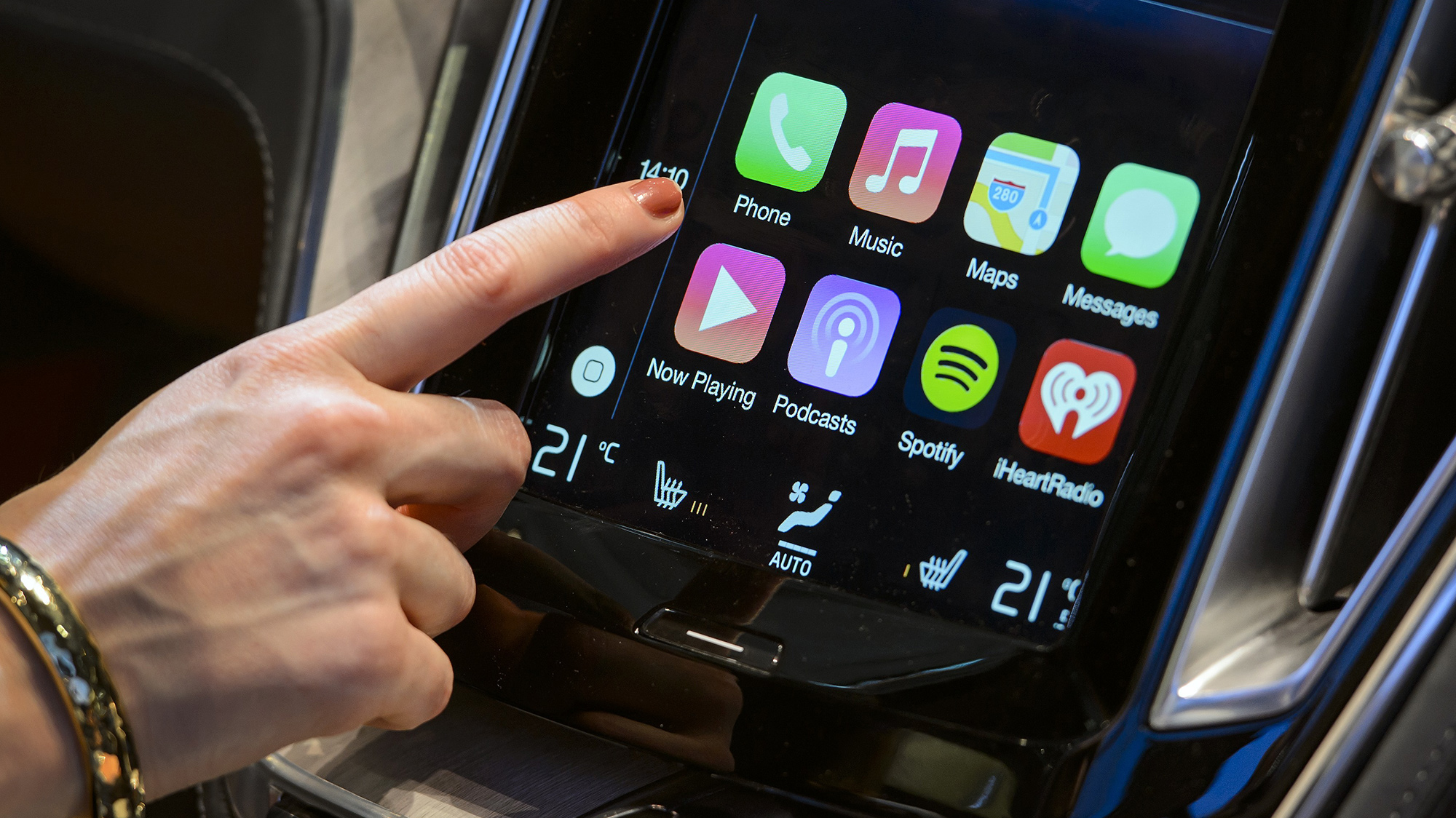 A person uses Apple CarPlay in a Volvo car.