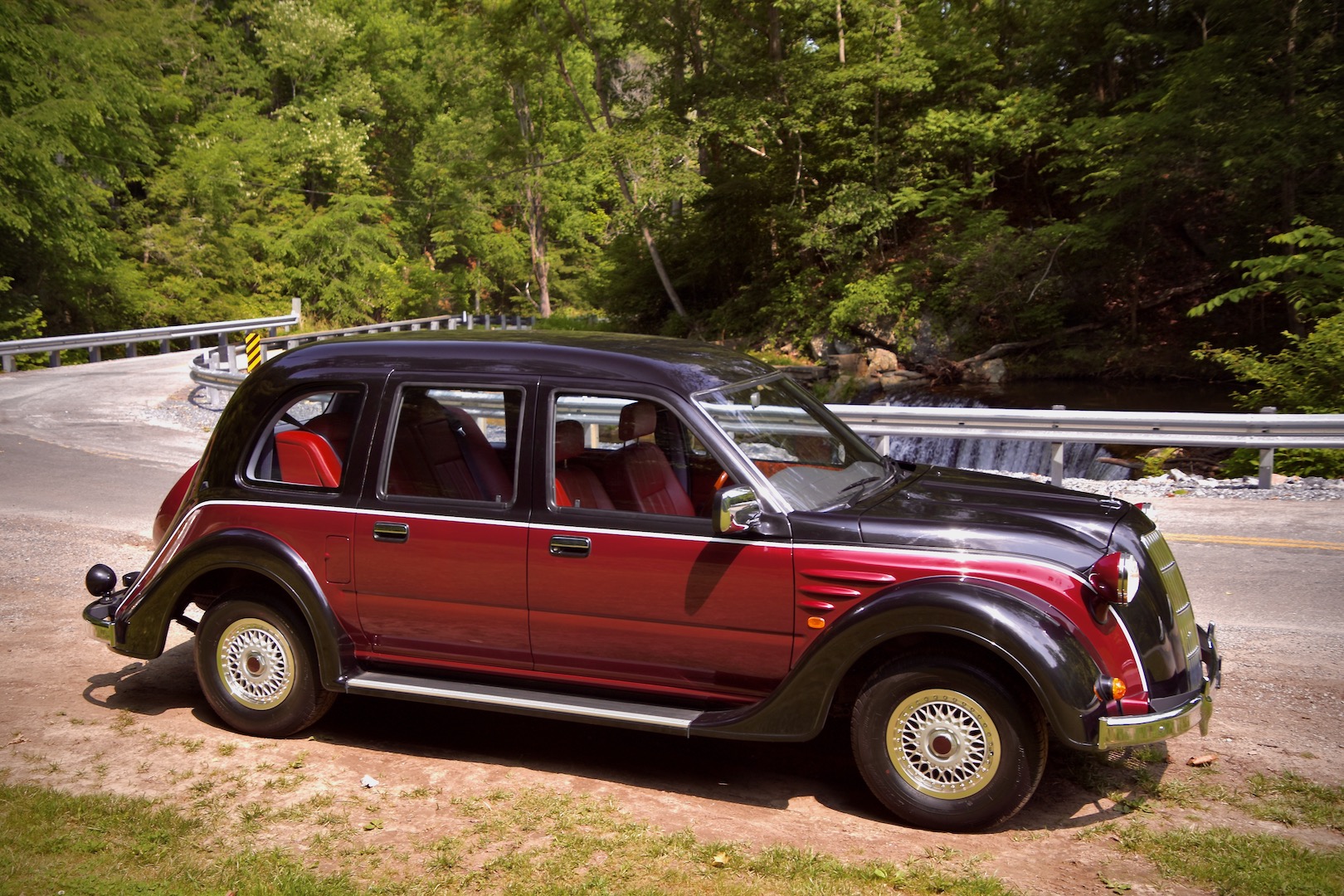 1996 Toyota Classic side view in front of a waterfall