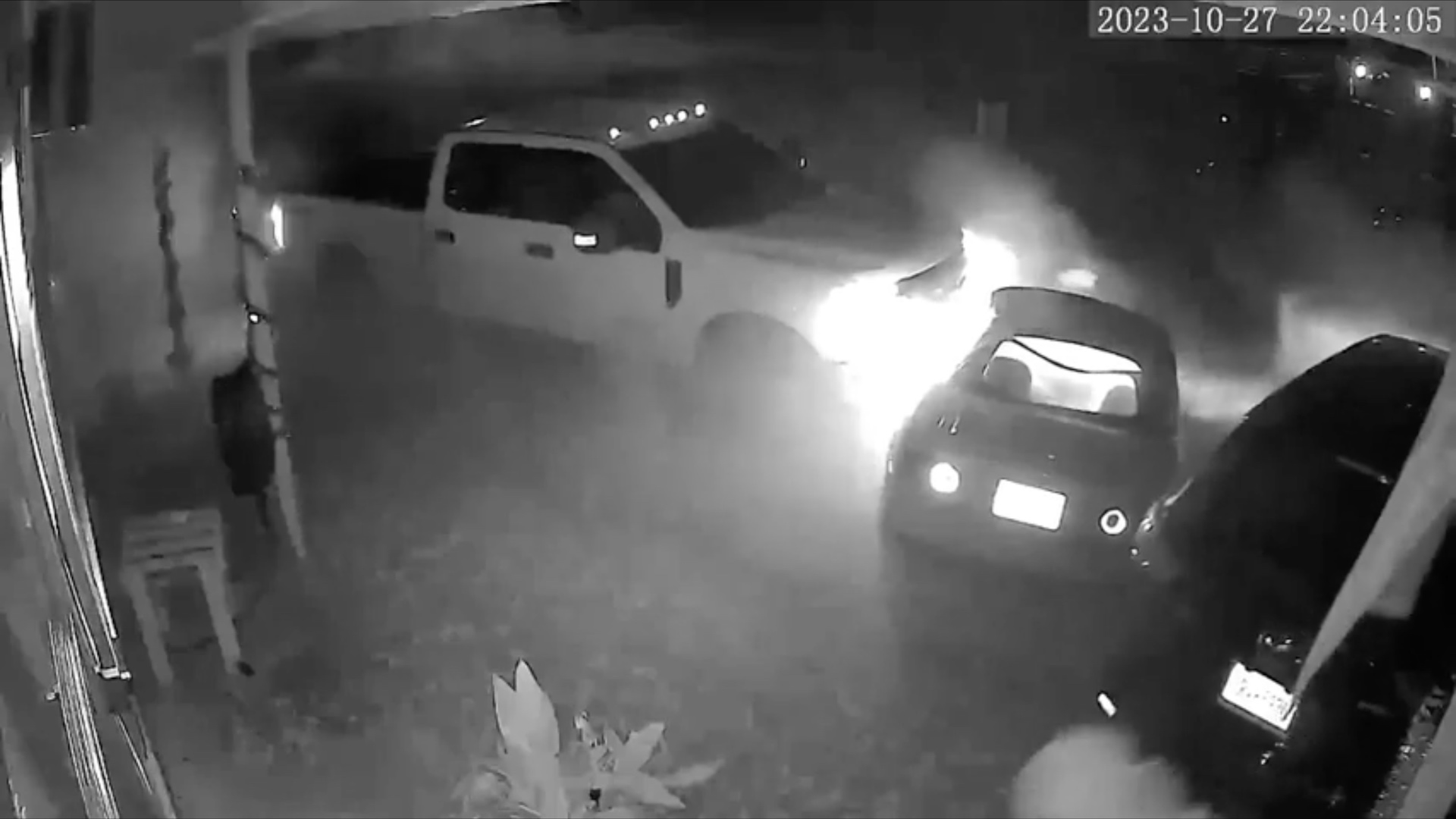 A Ford Super Duty captured on security camera destroying a couple's cars after nearly killing them