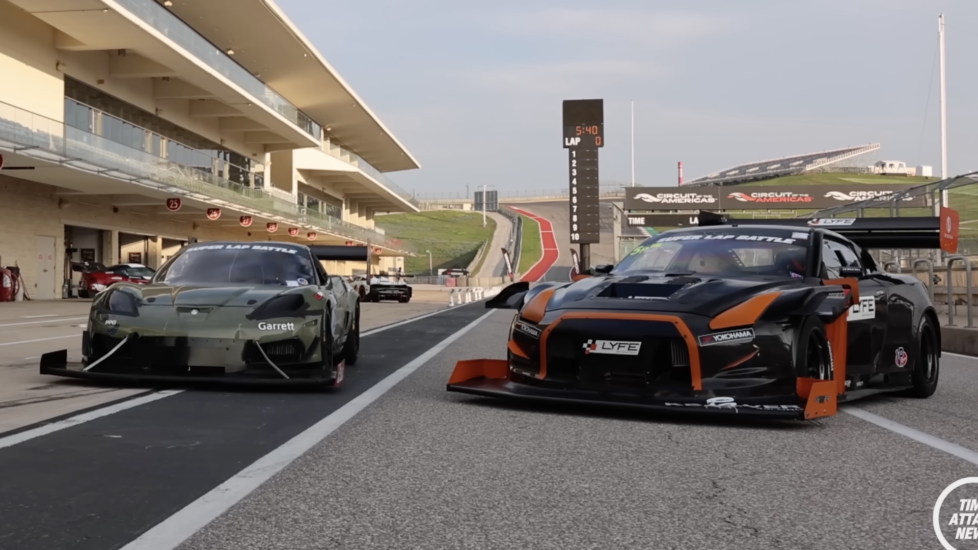 A heavily modified Chevrolet Corvette and Nissan GT-R in the pit lane at Circuit of the Americas