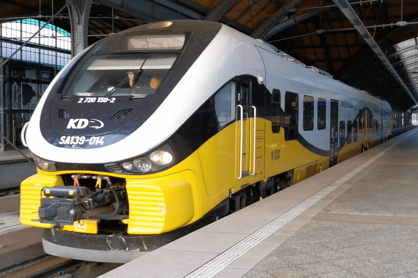 A Lower Silesian Railways train departs a station