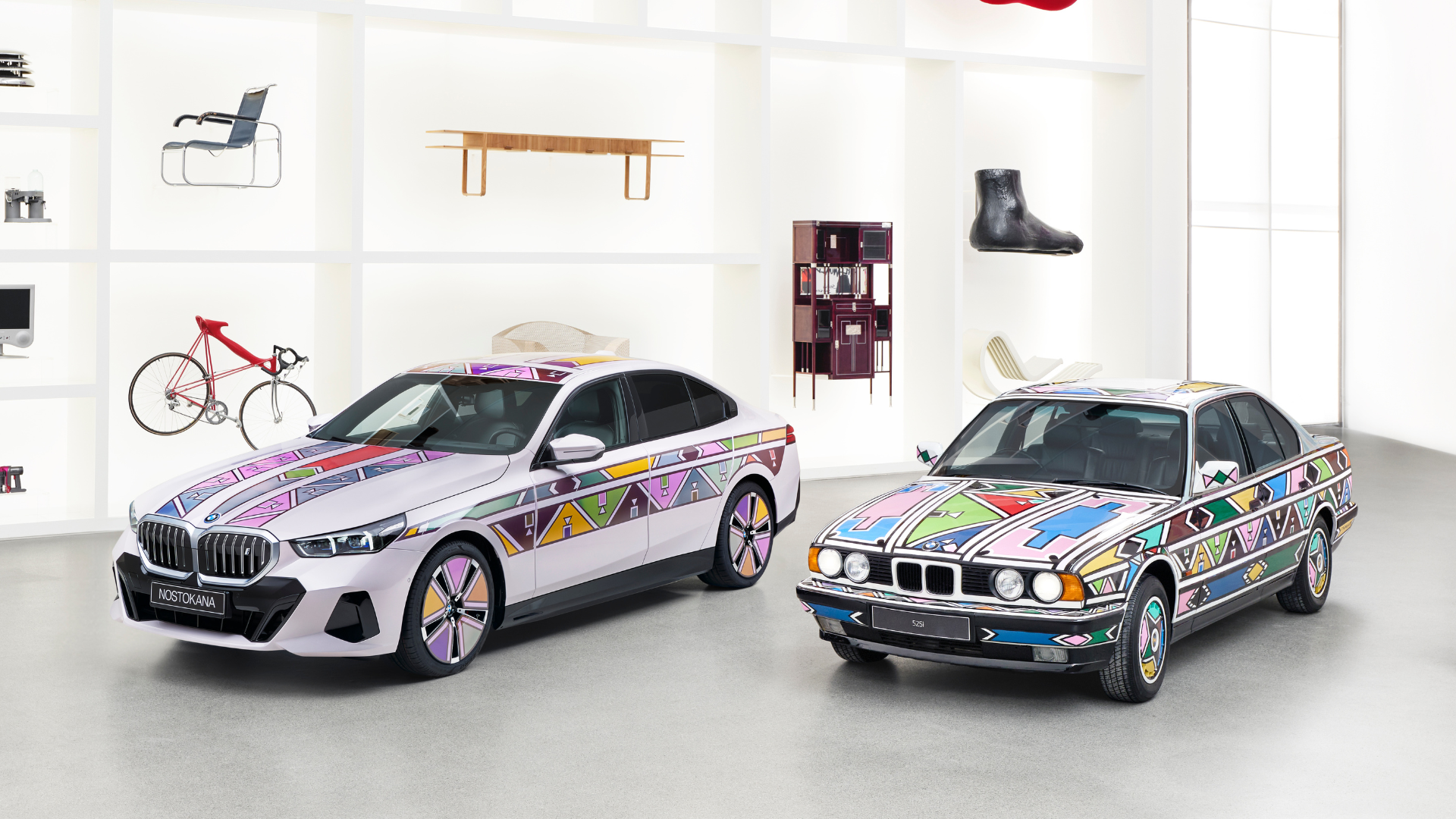 two white BMW cars in front of white walls