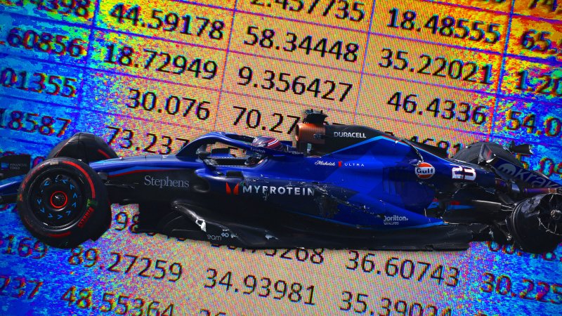 A crashed Williams Formula 1 car in front of a backdrop of a Microsoft Excel spreadsheet