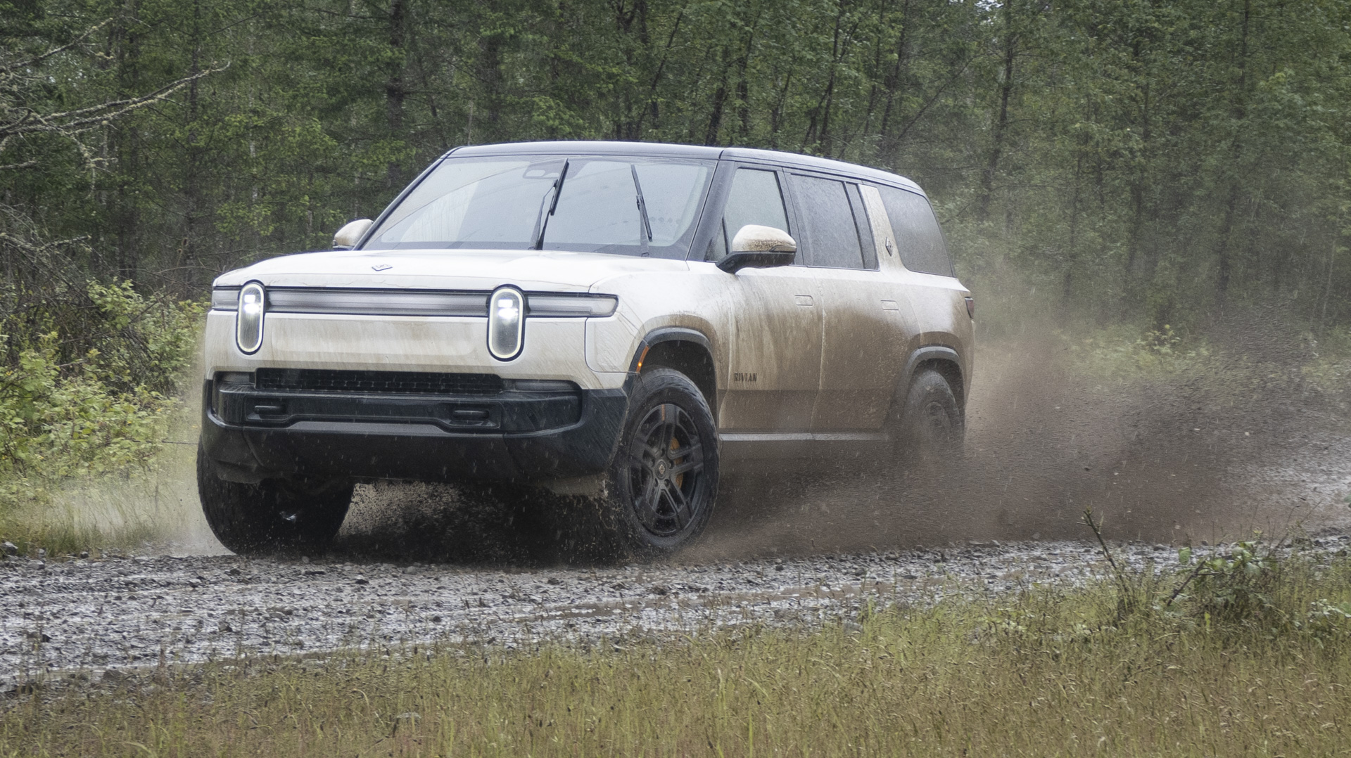 Electric truck splashing through mud.