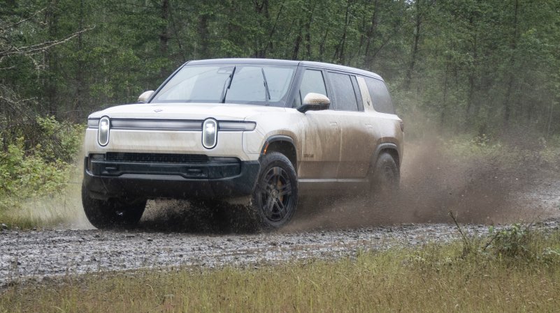 Electric truck splashing through mud.