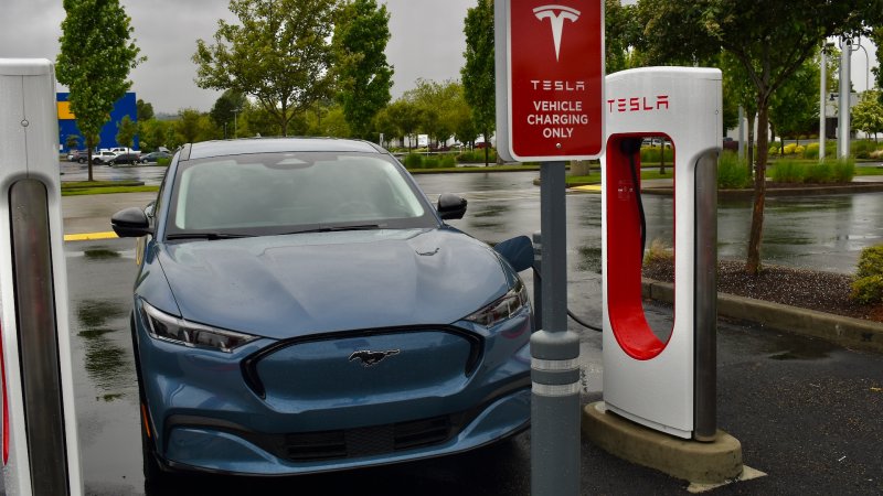 A 2024 Ford Mustang Mach-E Premium charges at a Tesla Supercharger station outside Seattle, WA