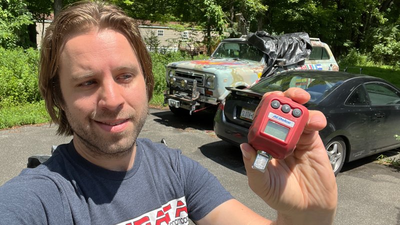 Mechanic holding an AC Delco torque adapter.