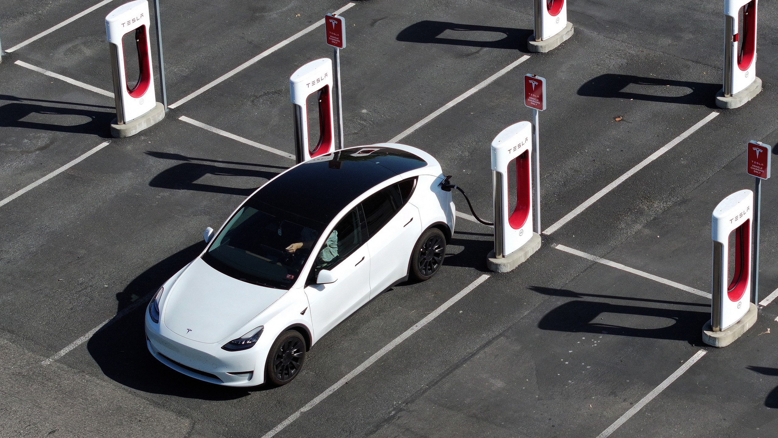 A Tesla Model Y charges at a Supercharger in California.