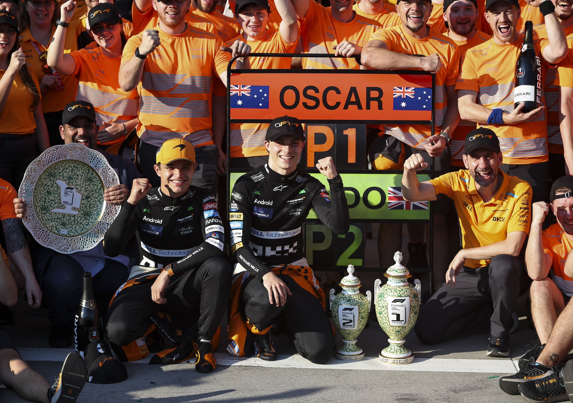 BUDAPEST, HUNGARY - JULY 21: Lando Norris of Great Britain and McLaren F1 Team (left) and Oscar Piastri of Australia and McLaren F1 Team celebrate with the McLaren F1 Team after the F1 Grand Prix of Hungary at Hungaroring on July 21, 2024 in Budapest, Hungary. (Photo by Qian Jun/MB Media/Getty Images)