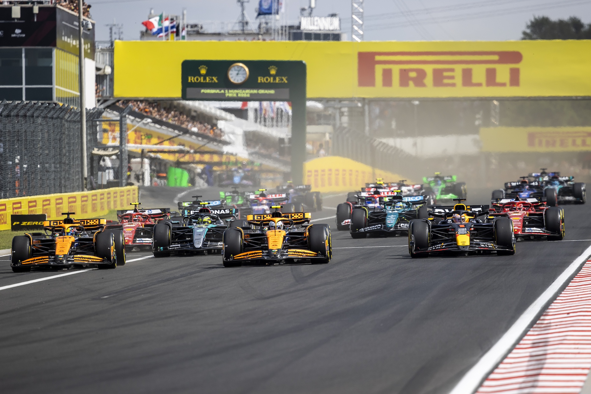 BUDAPEST, HUNGARY - JULY 21: (L-R) Oscar Piastri of Australia driving the (81) McLaren MCL38 Mercedes, Lando Norris of Great Britain driving the (4) McLaren MCL38 Mercedes and Max Verstappen of the Netherlands driving the (1) Oracle Red Bull Racing RB20 into turn one during the F1 Grand Prix of Hungary at Hungaroring on July 21, 2024 in Budapest, Hungary. (Photo by Arpad Kurucz/Anadolu via Getty Images)