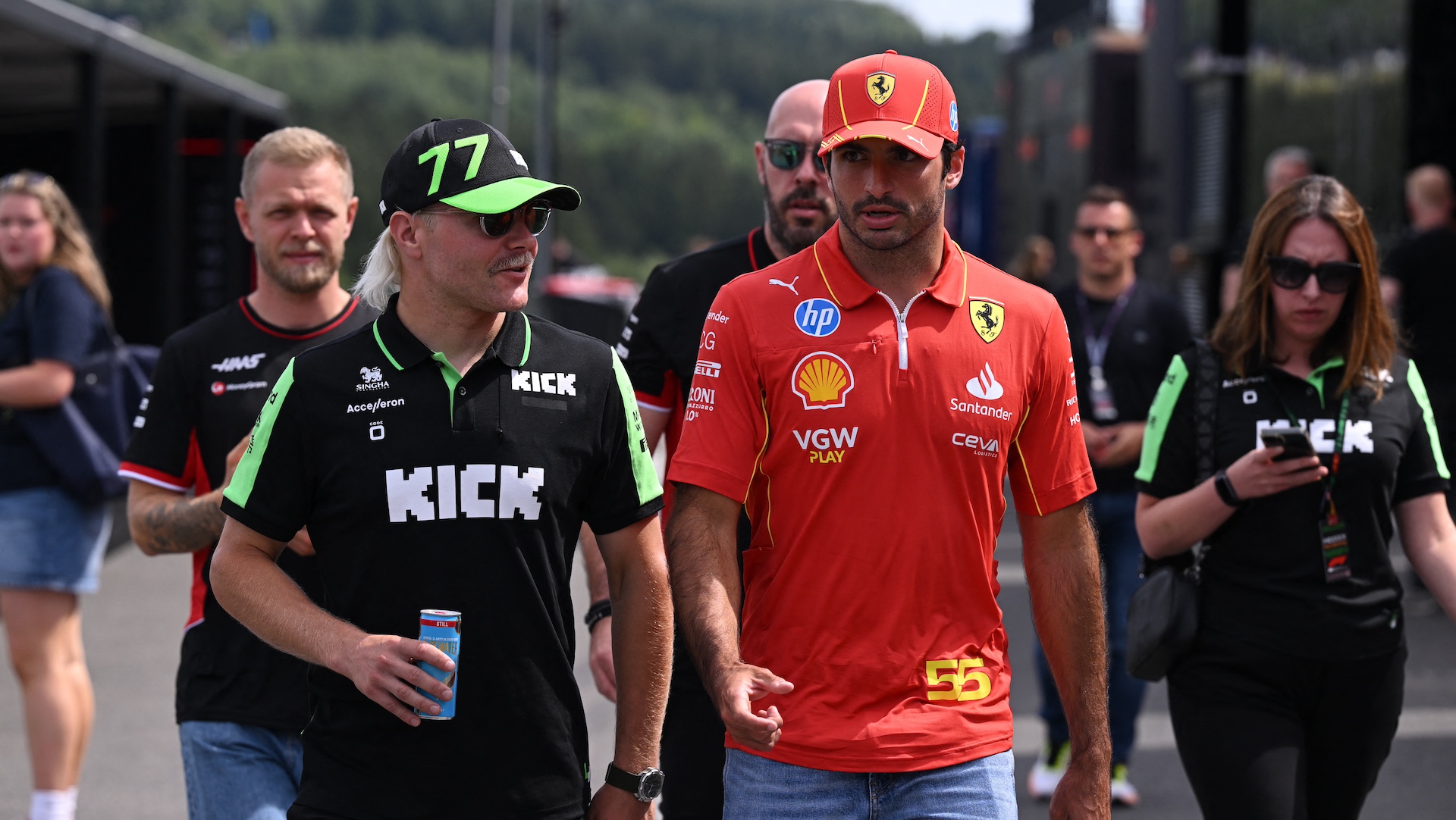 (L to R) Haas F1 Team's Danish driver Kevin Magnussen, Kick Sauber's Finnish driver Valtteri Bottas and Ferrari's Spanish driver Carlos Sainz walk in the paddock during previews at the Spa-Francophobias circuit in Spa on July 25, 2024, ahead of the Formula One Belgian Grand Prix. The Formula One Belgian Grand Prix at the Spa-Francorchamps circuit will be held on July 28, 2024. (Photo by JOHN THYS / AFP)