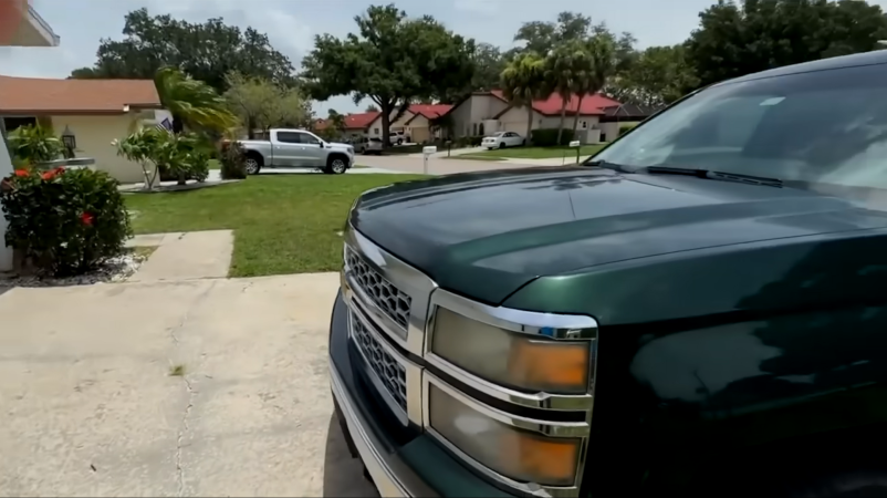 Image of green Chevy Silverado parked in Florida community.