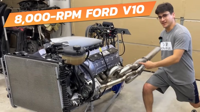 A man points at a heavily modified Ford 6.8-liter V10