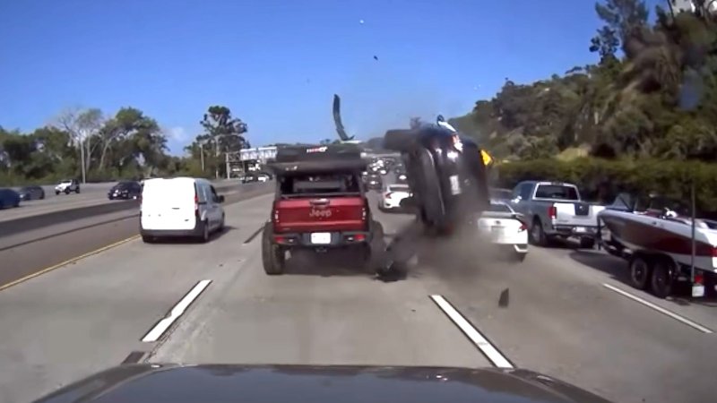 Nissan Murano rolls after striking Jeep on highway.